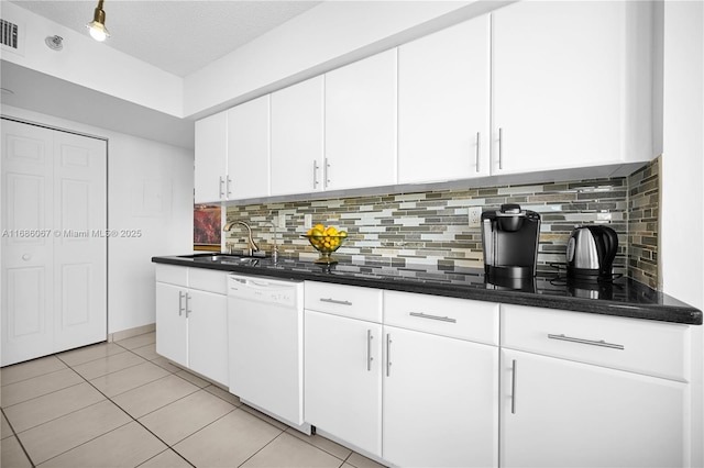 kitchen featuring a sink, light tile patterned floors, white cabinetry, and dishwasher