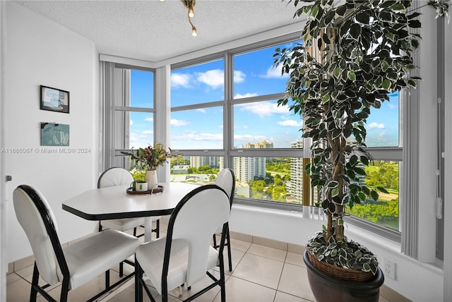 tiled dining area featuring a textured ceiling