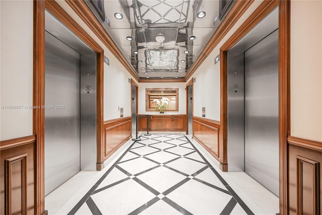 hall featuring ornamental molding, recessed lighting, elevator, and wainscoting