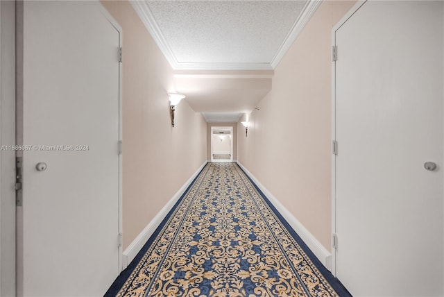 corridor with a textured ceiling and ornamental molding