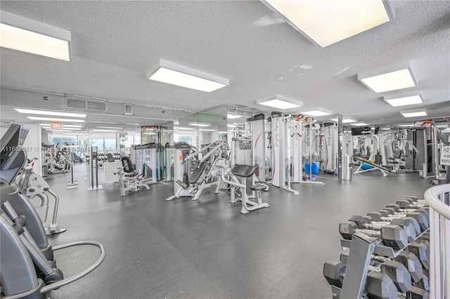 exercise room with a textured ceiling