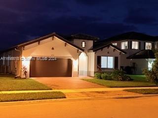 view of front of property featuring a yard and a garage