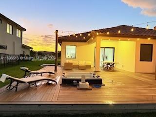 deck at dusk with outdoor lounge area