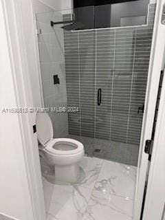 bathroom with toilet and walk in shower