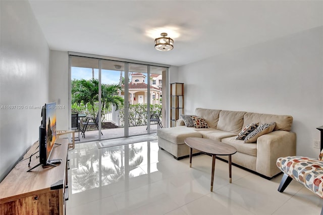 living room featuring light tile patterned floors and expansive windows