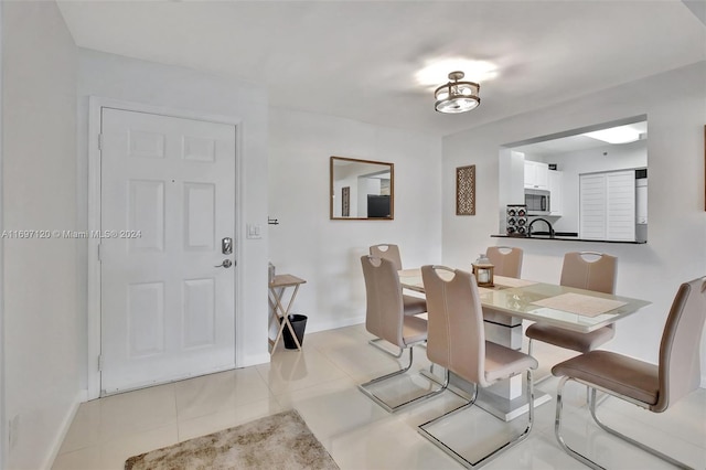 dining space featuring light tile patterned floors