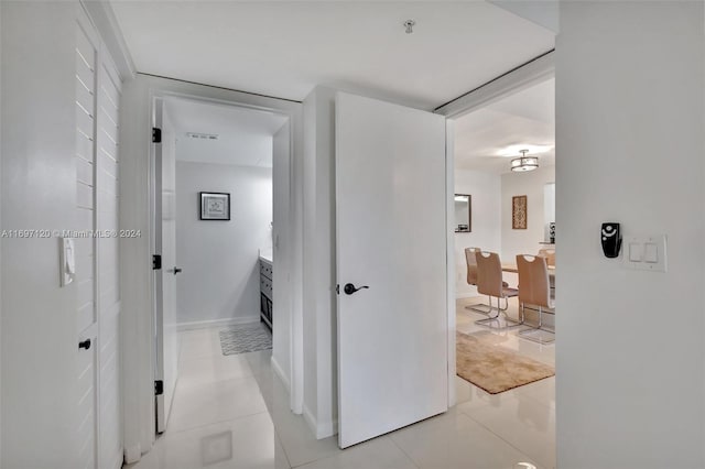 hall featuring light tile patterned flooring