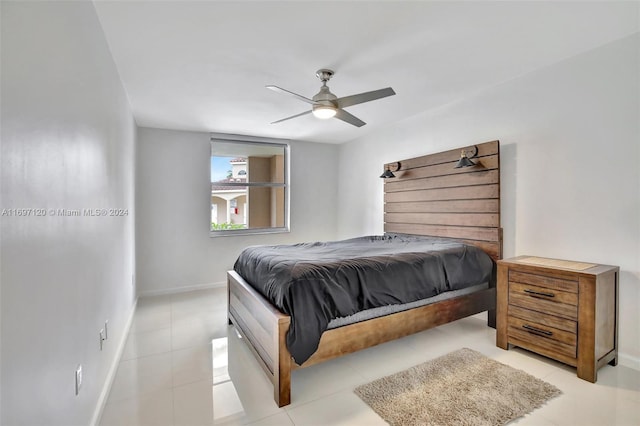 tiled bedroom featuring ceiling fan