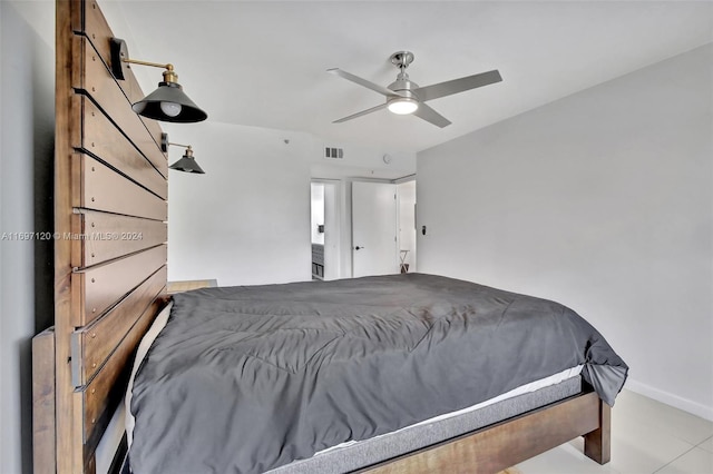 bedroom featuring ceiling fan and a barn door