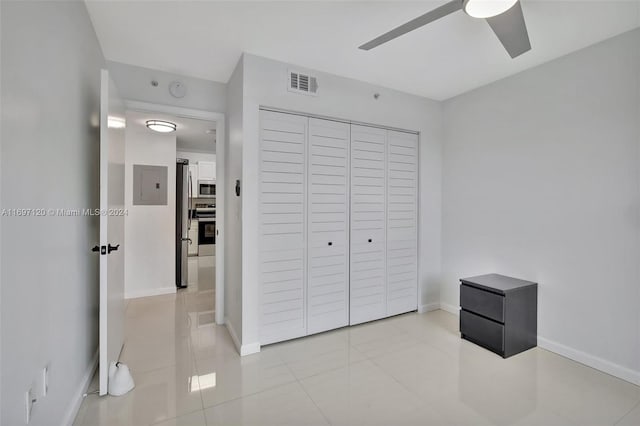 bedroom featuring a closet, stainless steel refrigerator, and ceiling fan