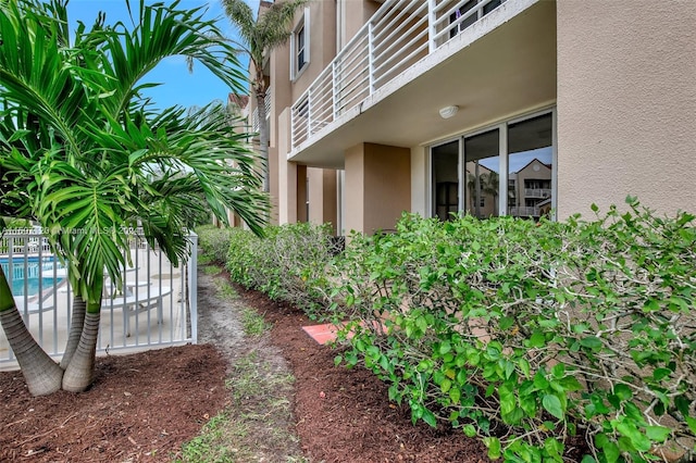 view of side of property featuring a fenced in pool