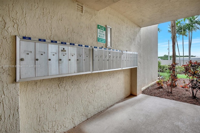 exterior space with a water view and a mail area