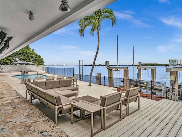 dock area featuring a fenced in pool, outdoor lounge area, and a water view