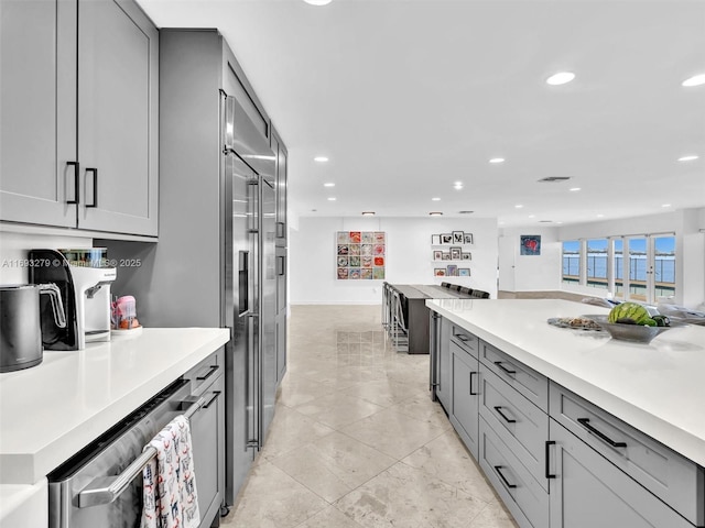 kitchen with gray cabinetry and stainless steel appliances