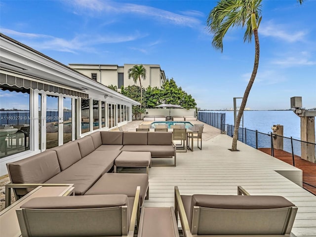 view of patio featuring outdoor lounge area, a water view, and a pool