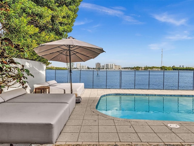 view of pool with a patio area and a water view