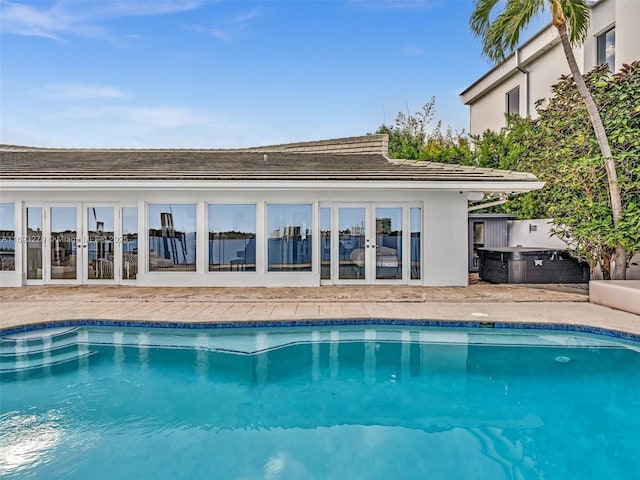 view of pool with french doors