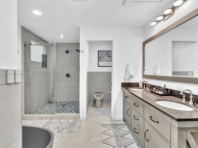 bathroom with vanity, a shower with door, a bidet, and tile walls