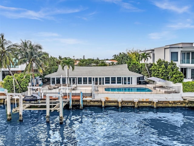 back of house with a patio and a water view