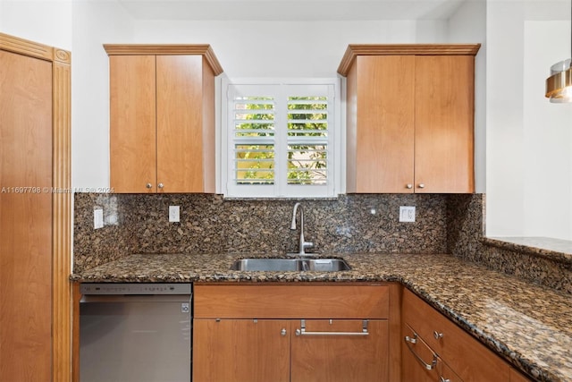 kitchen with sink, decorative backsplash, dark stone counters, and black dishwasher