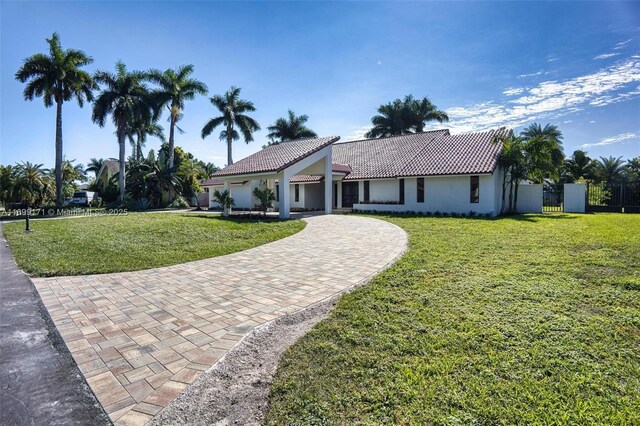 mediterranean / spanish house with a front lawn