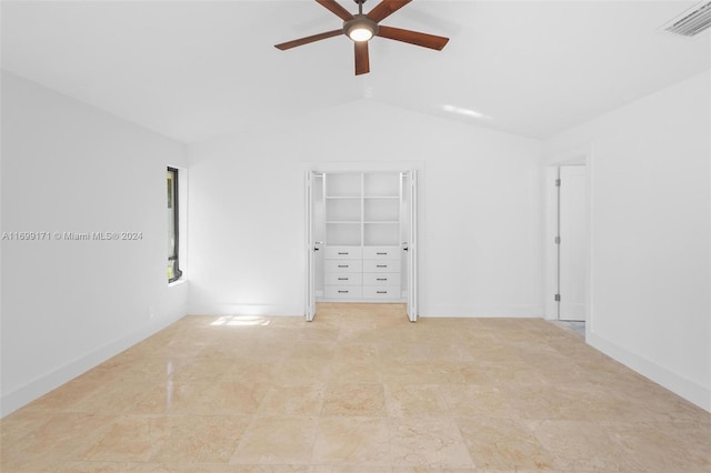 unfurnished bedroom with ceiling fan, a closet, and lofted ceiling