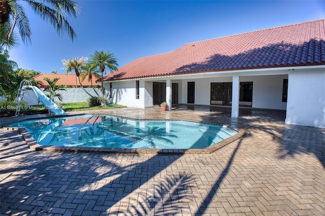 view of pool with a patio and a water slide