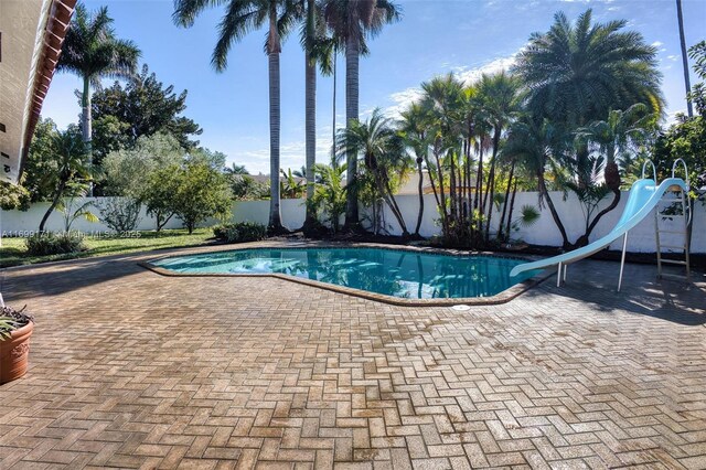 view of swimming pool featuring a patio area and a water slide