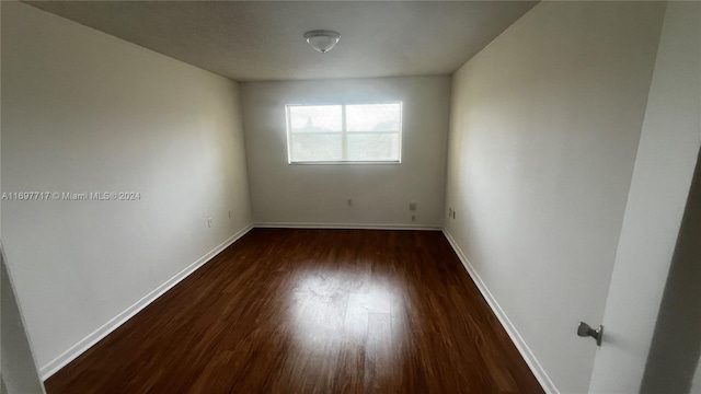 spare room featuring dark hardwood / wood-style flooring