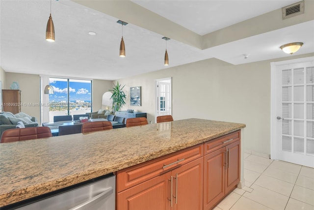 kitchen featuring pendant lighting, light tile patterned flooring, and light stone counters