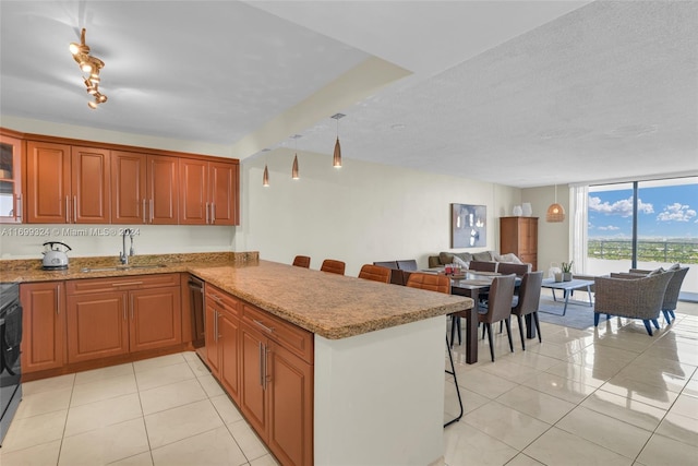 kitchen with kitchen peninsula, light tile patterned floors, a textured ceiling, and sink