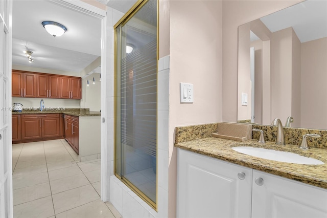 bathroom featuring tile patterned flooring, walk in shower, and sink