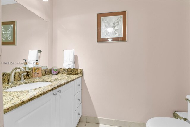 bathroom featuring tile patterned floors, vanity, and toilet