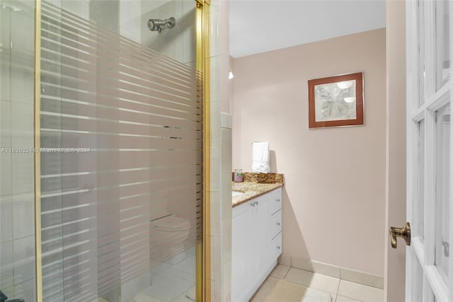 bathroom with tile patterned flooring, vanity, and a shower with door