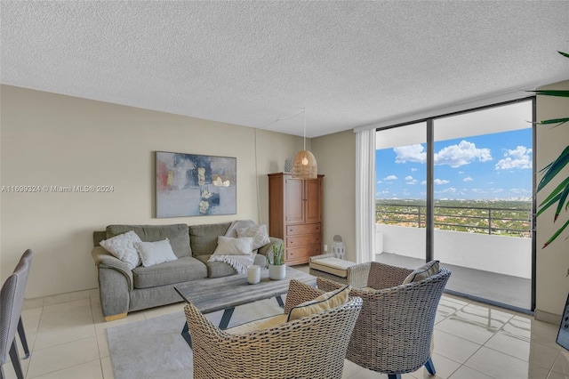 living room with light tile patterned floors, a textured ceiling, and floor to ceiling windows