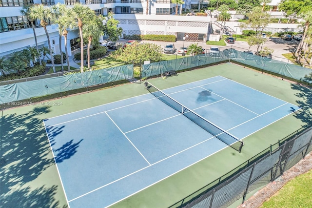 view of tennis court with basketball hoop