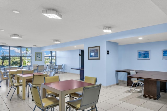 dining room featuring light tile patterned floors and a textured ceiling