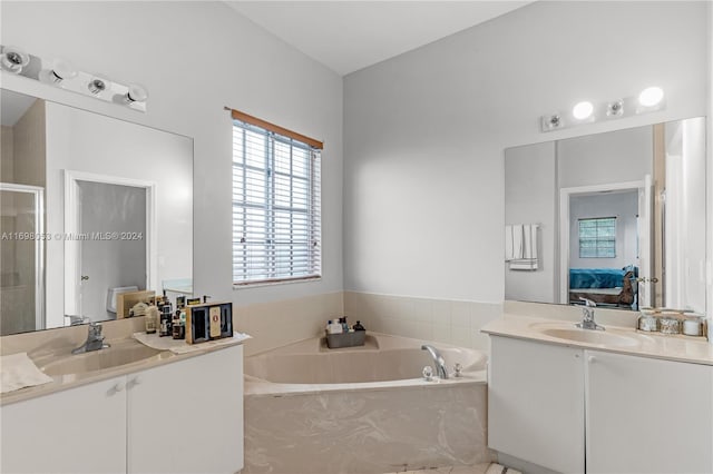 bathroom with vanity and independent shower and bath