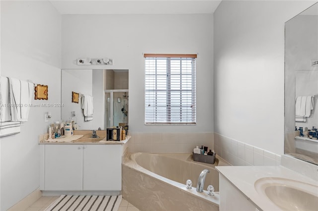 bathroom featuring tile patterned flooring, vanity, and separate shower and tub