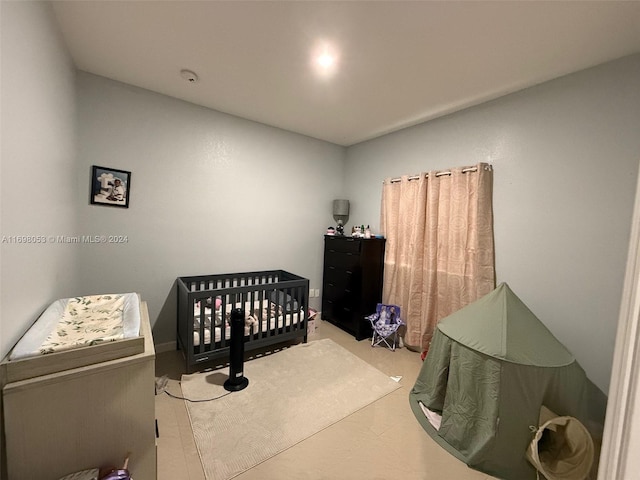 bedroom featuring a nursery area