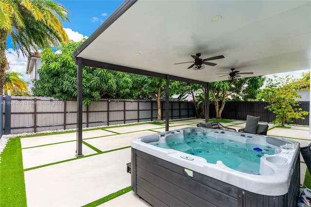 view of swimming pool featuring ceiling fan, a patio, and a hot tub