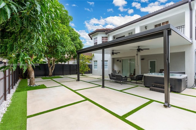 rear view of property with a patio, a hot tub, and ceiling fan