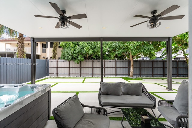 view of patio / terrace with a hot tub and ceiling fan