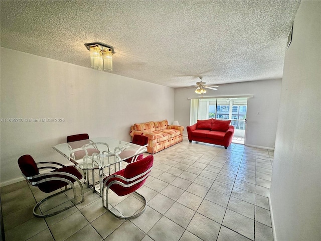 living room with ceiling fan, light tile patterned floors, and a textured ceiling