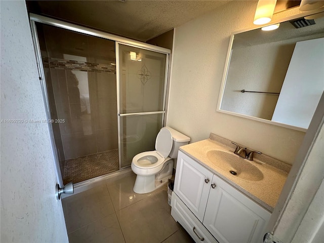 bathroom featuring tile patterned floors, an enclosed shower, vanity, a textured ceiling, and toilet