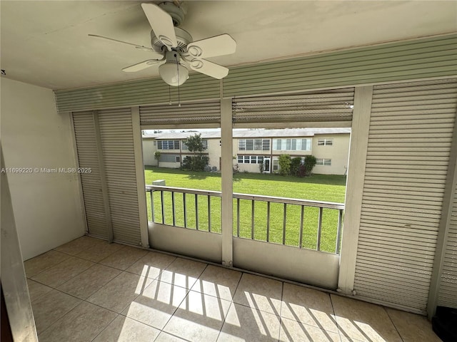 unfurnished sunroom featuring ceiling fan and a healthy amount of sunlight