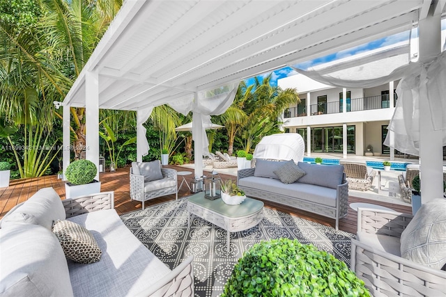 view of patio / terrace with an outdoor living space, a balcony, and a swimming pool