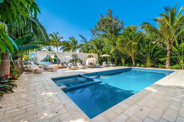 view of swimming pool with an in ground hot tub and a patio