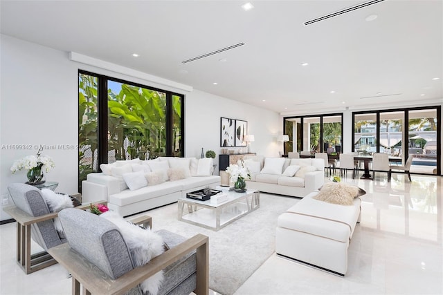 living room featuring floor to ceiling windows and a wealth of natural light