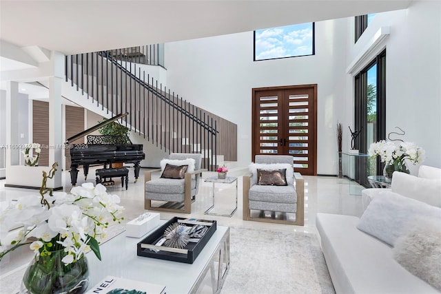 living room with french doors and a high ceiling